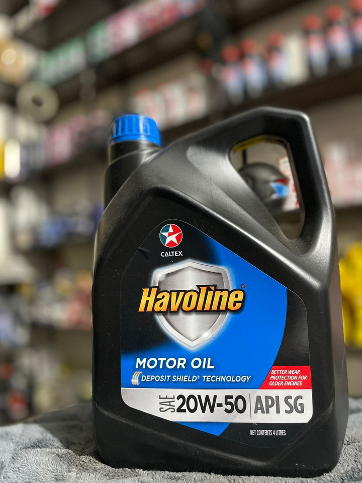 Havoline motor oil bottle with Caltex logo in a store setting