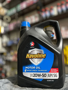 Havoline motor oil bottle with Caltex logo in a store setting